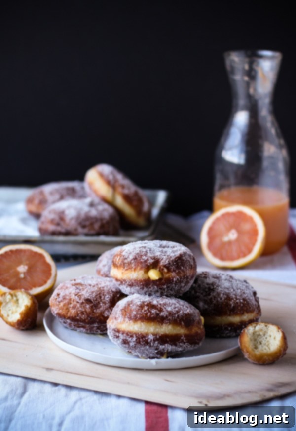Zesty Grapefruit Doughnut Clouds 5 Grapefruit curd filling being piped into a fried doughnut