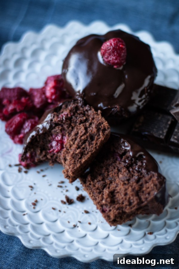 Decadent Dark Chocolate Chunk Raspberry Muffins 2 Dark Chocolate Chunk Raspberry Muffins, warm from the oven with raspberries and chocolate chunks