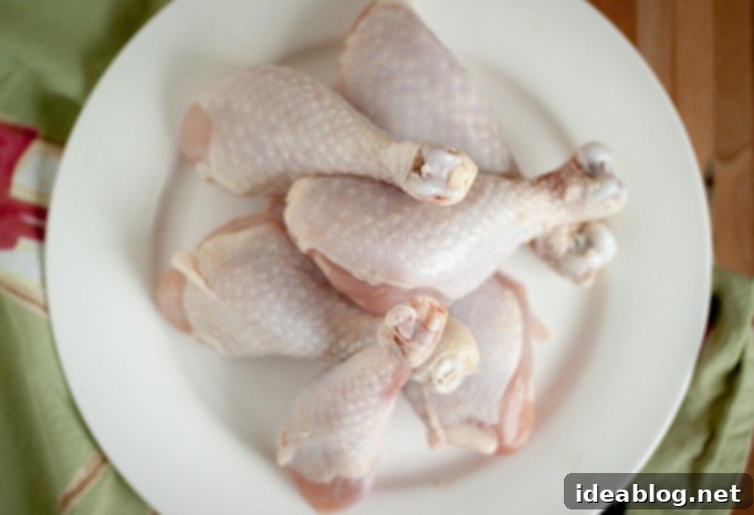 Tender Chicken Braised in Red Wine and Tomato Sauce 4 Beautifully seared chicken drumsticks ready for braising in a Dutch oven