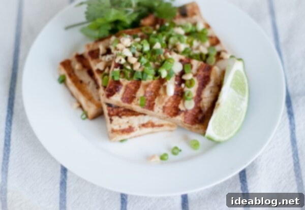 Umami Grilled Tofu Power Bowl 7 Close up of a vibrantly topped Grilled Asian Tofu Bowl, showcasing the generous garnishes