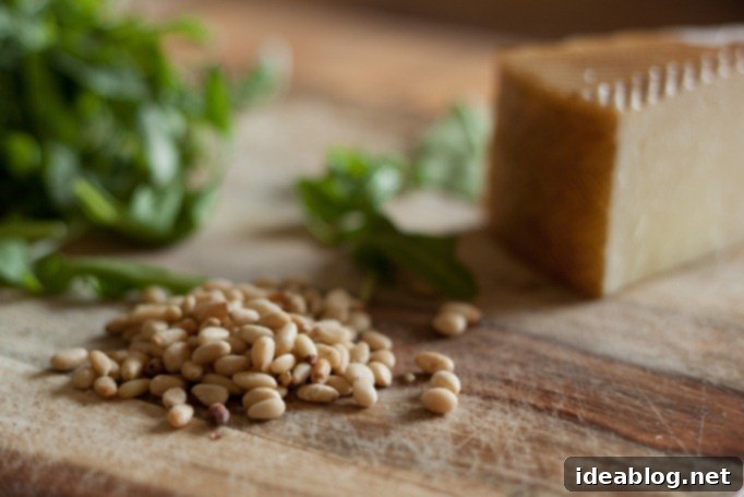Garden Fresh Arugula Pesto 3 Arugula Pesto Ingredients on a cutting board